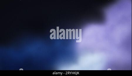 Blurred colored smoke on black background, purple blue white colours with grainy effect in dark, copy space Stock Photo