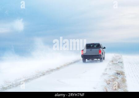 Pick-Up Truck on road in winter with heavy wind Stock Photo