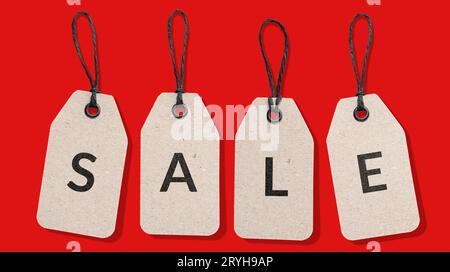 SALE word on cardboard price tag set isolated on red background. Sale sign Stock Photo