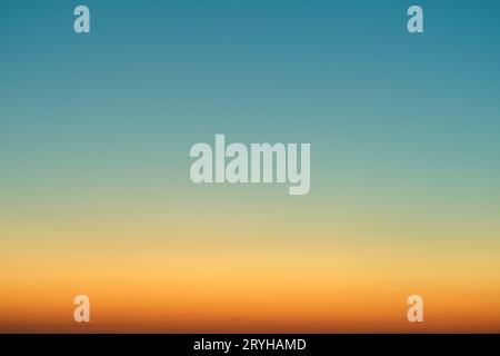 Orange-blue gradient of clear cloudless sky during sunrise Stock Photo