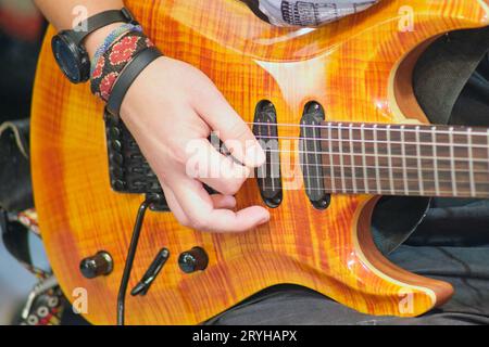 Unidentified musician plays the guitar during Music Festival Stock Photo