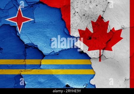 Flags of Aruba and Canada painted on cracked wall Stock Photo