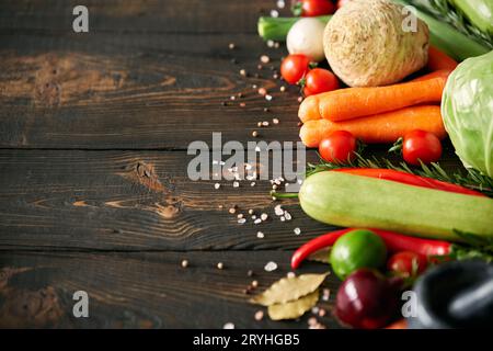 Assorted raw organic vegetables on dark wooden background with copy space Stock Photo