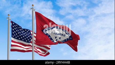 Arkansas state flag waving with the national flag of the United States of America on a clear day. Stock Photo