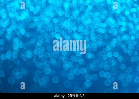 An abstract blue background with sparkle lights and bokeh. Useful as Christmas background or greeting card. Stock Photo