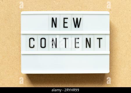 Lightbox with word new content on wood background Stock Photo