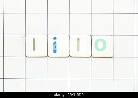 Colorful tile letter in word LILO (abbreviation of last in last out) on white grid background Stock Photo