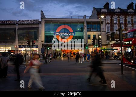 Brixton, London, UK: Pedestrian crossing on Brixton Road opposite Brixton underground station. Evening view with people and traffic. Stock Photo