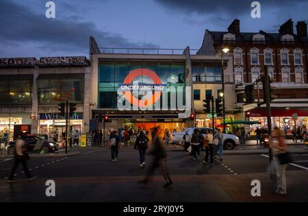 Brixton, London, UK: Pedestrian crossing on Brixton Road opposite Brixton underground station. Evening view with people and traffic. Stock Photo