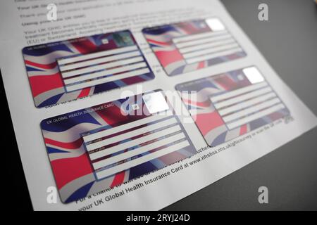 UK Global Health Insurance Cards GHIC seen attached to the letter. Stafford, United Kingdom, October 1, 2023 Stock Photo