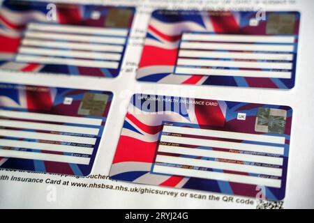 UK Global Health Insurance Cards GHIC seen attached to the letter. Stafford, United Kingdom, October 1, 2023 Stock Photo