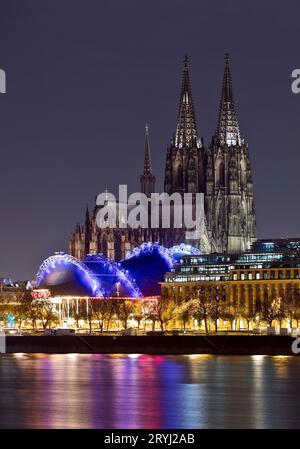 City panorama with only dimly lit Cologne Cathedral and the Rhine at night, Cologne, Germany, Europe Stock Photo