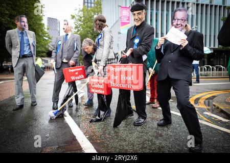 Manchester, UK. 01st Oct, 2023. Protesters prepare themselves to march past the conference. Thousands of people march through the city for a national demonstration during the Conservative Party Conference. Organised by The Peoples Assembly and joined by trade unions the demands include to end the cost of living crisis and to defend the NHS. Credit: Andy Barton/Alamy Live News Stock Photo