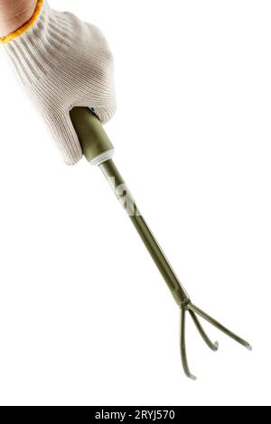 Small garden rake in hand dressed in a white glove Stock Photo