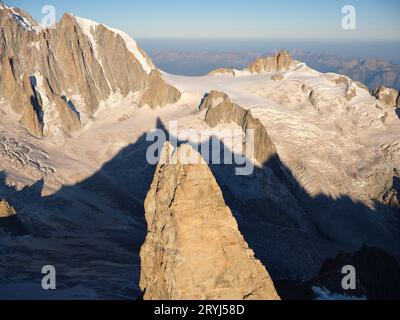 AERIAL VIEW. Dent du Géant (elevation: 4013 meters) and its shadow on the Géant Glacier. Chamonix, Haute-Savoie, Auvergne-Rhône-Alpes, France. Stock Photo