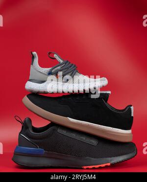 Sport shoes stack  isolated on red studio background side view Stock Photo