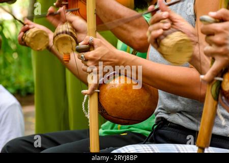 Several musicians playing an Afro Brazilian percussion musical instrument Stock Photo