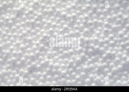 Small White Foam Balls Background Texture Close Up. Stock Photo