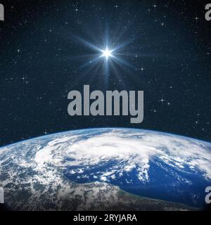 Bright star shines above the Earth in starry space. Birth of Jesus concept, Star of Bethlehem. Elements of this image furnished by NASA Stock Photo