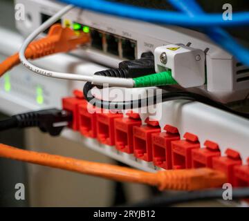 Communication equipment connected with copper and optical cables Stock Photo