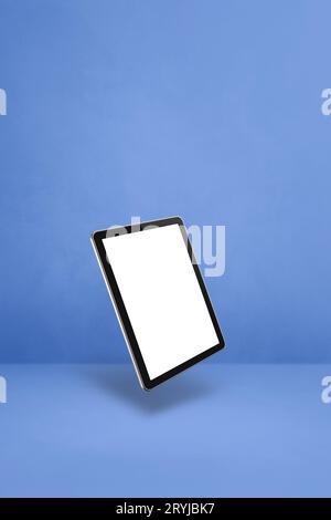 Floating tablet pc computer isolated on blue. Vertical background Stock Photo