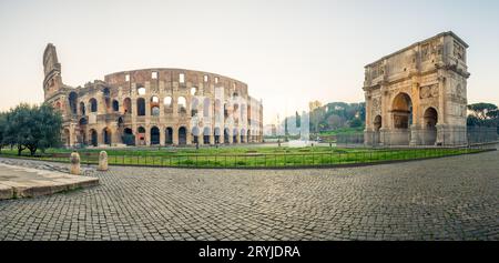 Panoramic view of Colosseum and Constantine arch at sunrise. Rome, Italy Stock Photo