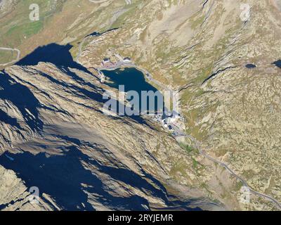 AERIAL VIEW. Grand Saint-Bernard Pass (2469m) and international border at the lake between Italy (second half of the lake and behind) and Switzerland. Stock Photo