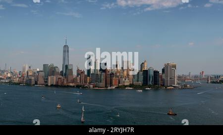 Aerial cityscape about Manhattan in New York city. Hudson and East river's esuary on the foreground with sailing boats and ferrys. Stock Photo