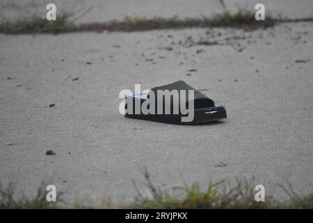 Jersey, United States. 01st Oct, 2023. Shoe left at the crime scene. Five people were reportedly shot outside 224 Lounge in Jersey City. At approximately 2:42 AM, reports came in of multiple people shot on Culver Avenue. Daybreak, debris left from the shooting was present at the scene outside the lounge including crime scene tape, blood on the sidewalk and shoes. Roses were also left at the crime scene. Information from authorities was not immediately available. Credit: SOPA Images Limited/Alamy Live News Stock Photo