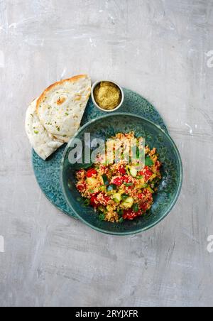 Traditional Moroccan vegetable couscous with pita bread and hummus served as top view on a Nordic Design plate with copy space Stock Photo