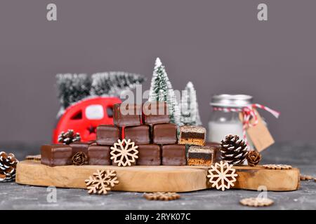 German sweets called 'Dominosteine'. Traditional Christmas candy consisting of gingerbread, jelly and marzipan layers covered with chocolate icing Stock Photo