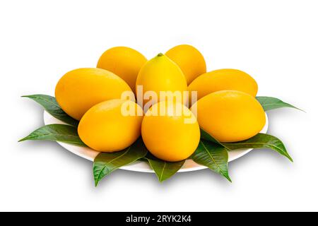 Ripe sweet yellow marian plum decorated in white ceramic dish isolated on white background. Stock Photo