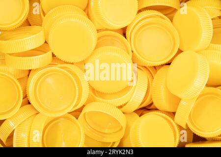 Yellow plastic screw caps background Stock Photo