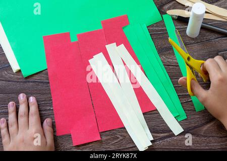 Instruction step 2. Paper Fan watermelon and origami paper ice cream on a wooden table. Childrens art project, handmade, crafts Stock Photo
