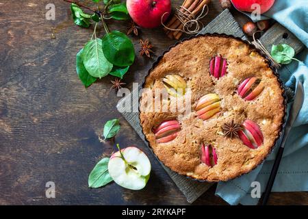 Apple baking gluten free seasonal. Autumn pie with apples, hazelnut and cinnamon on a wooden table. Top view flat lay background Stock Photo