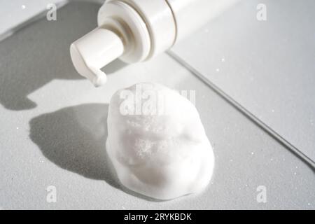 Photo of the texture of cosmetic foam with a bottle. Stock Photo