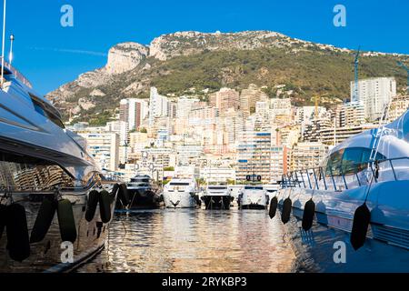 Monte Carlo, Monaco - Port Hercule with luxury yachts,  boats, and scenery skyline Stock Photo