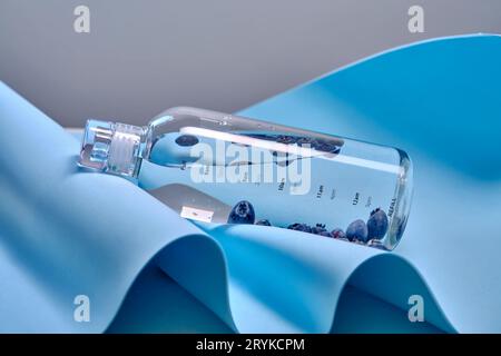 A glass bottle of pure water with blueberries. Stock Photo