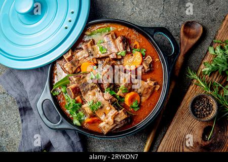 Beef ribs Bourguignon. Beef ribs stewed with carrot, onion in red wine. France dish Stock Photo