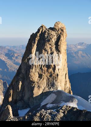 AERIAL VIEW. Dent du Géant (4013m) viewed from the east. 3 climbers on top give a sense of scale to this incredible granite peak. Chamonix, France. Stock Photo