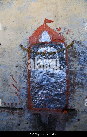Shiva deity painted in silver and red on a wall in Jodhpur in India Stock Photo