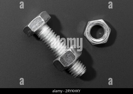 Bolt and nut isolated on black background Stock Photo