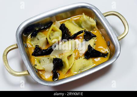 pumpkin and mushroom ravioli pasta served in a copper pan Stock Photo