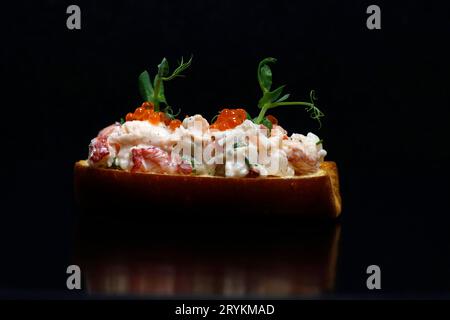 lobster roll open face sandwich close up with black background Stock Photo