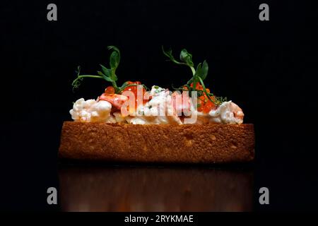 lobster roll open face sandwich with black background Stock Photo