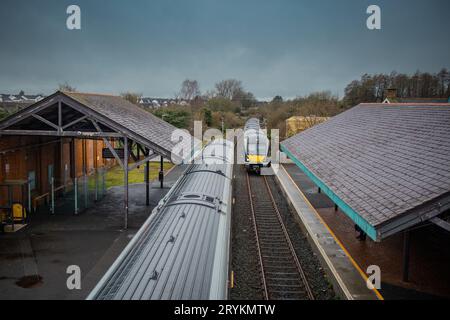 Two diesel trains are crossing at ballymoney train station in northern ireland. Looking towards the trains and train tracks from the pedestrian overpa Stock Photo