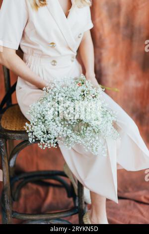 girl holding a bouquet of white gypsophila, bridal wedding bouquet