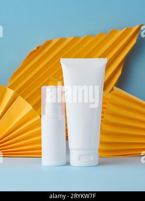 White plastic tubes for cosmetic products on a blue background, advertising and branding of products Stock Photo