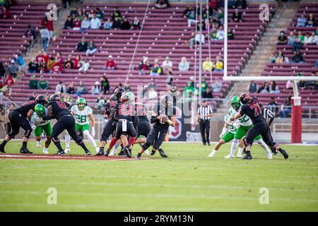 Stanford quarterback Justin Lamson, right, runs the ball against ...