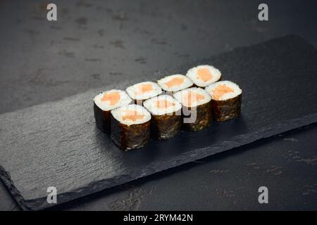 https://l450v.alamy.com/450v/2rym42n/roll-with-salmon-on-dark-background-sushi-menu-japanese-food-2rym42n.jpg